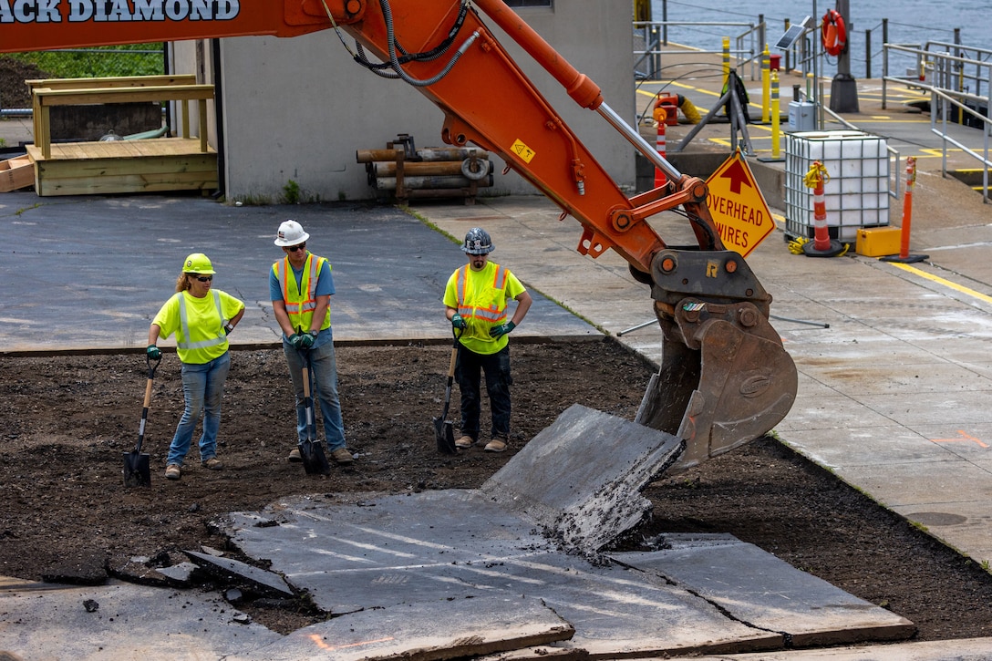 Construction workers make groundbreaking progress at a construction site at a navigational lock along a river.