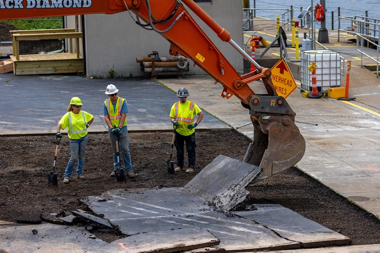 Construction workers make groundbreaking progress at a construction site at a navigational lock along a river.