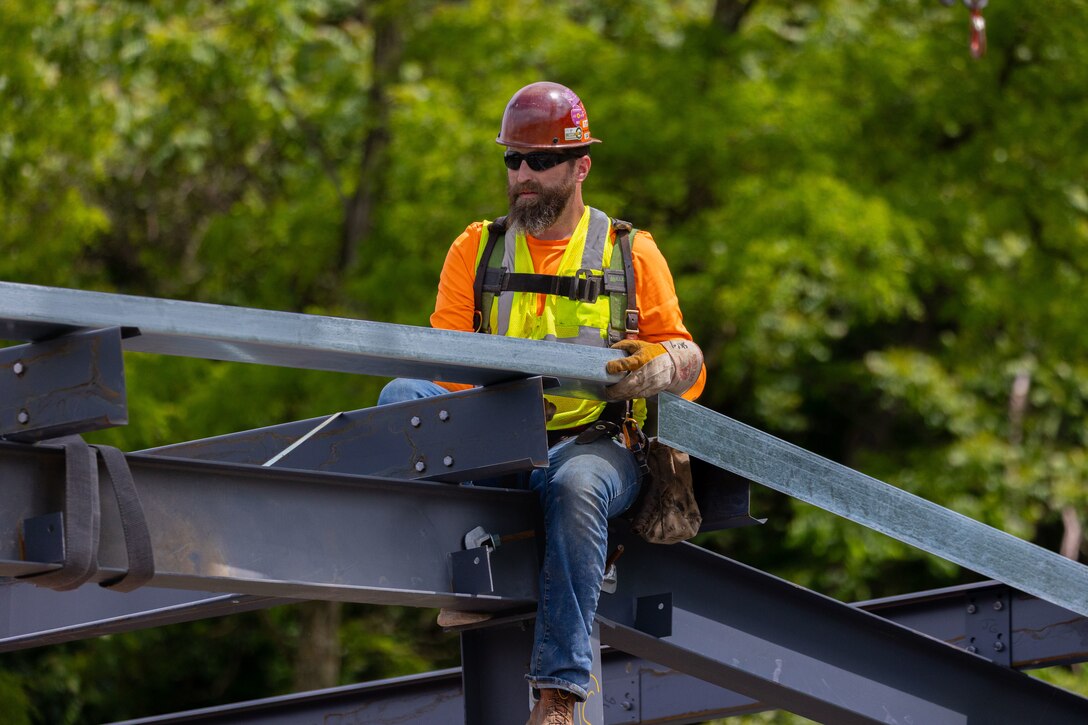 Construction workers make groundbreaking progress at a construction site at a navigational lock along a river.