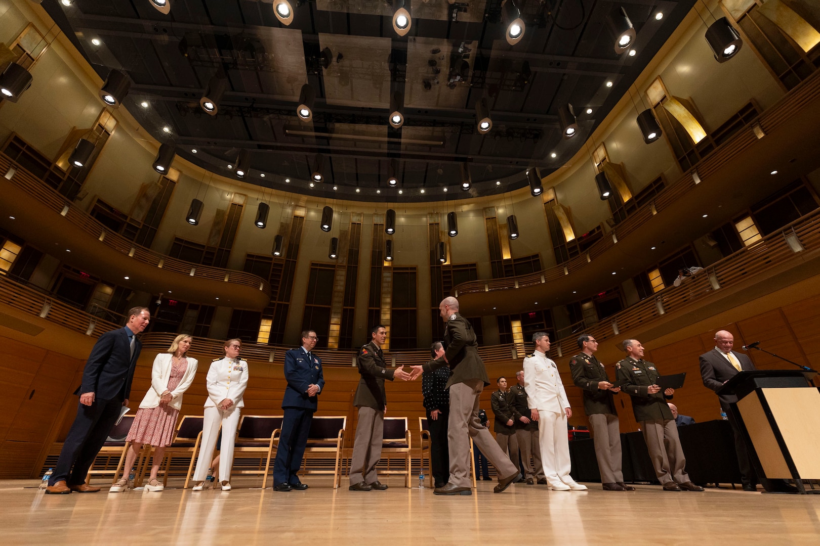 A U.S. Army medical officer shakes hands with the official party during the 2025 National Capital Consortium Graduation Ceremony at Strathmore, Bethesda, Md., June 13. The event marked a significant milestone for the 220 interns, residents, and fellows from Walter Reed National Military Medical Center and the National Capital Consortium, as they prepared to embark on the next chapter in their military career. (DOD photo by Ricardo J. Reyes)