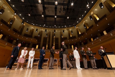 A U.S. Army medical officer shakes hands with the official party during the 2025 National Capital Consortium Graduation Ceremony at Strathmore, Bethesda, Md., June 13. The event marked a significant milestone for the 220 interns, residents, and fellows from Walter Reed National Military Medical Center and the National Capital Consortium, as they prepared to embark on the next chapter in their military career. (DOD photo by Ricardo J. Reyes)