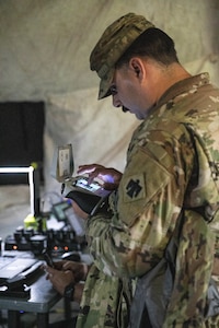 Spc. Whalen Phipps, an unmanned aircraft systems operator, assigned to Detachment 1, Delta Company, 545th Brigade Engineer Battalion, 45th Infantry Brigade Combat Team, operates an unmanned aircraft system during a UAS exercise on June 12, 2025 at Camp Gruber Training Center, Oklahoma. The exercise, hosted by the 45th IBCT and featured numerous UAS and counter-UAS systems, focused on preparing infantry Soldiers to react to UAS threats. (Oklahoma National Guard photo by Spc. Cambrie Cannon)