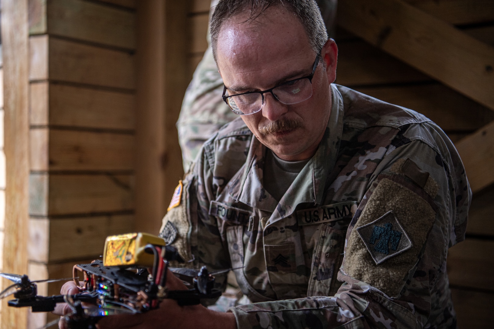 Sgt. Corey Fountain, a tactical unmanned aircraft system repairer assigned to Detachment 1, Delta Company, 545th Brigade Engineer Battalion, 45th Infantry Brigade Combat Team, prepares a small first-person view drone to be launched during a UAS exercise at Camp Gruber Training Center, Oklahoma, on June 12, 2025. The exercise, hosted by the 45th IBCT and featured numerous UAS and counter-UAS systems, focused on preparing infantry Soldiers to react to UAS threats. (Oklahoma National Guard photo by Staff Sgt. Anthony Jones)