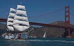 SAN FRANCISCO, (July 23, 2008) The Coast Guard Cutter Eagle sails under the Golden Gate Bridge today, leading 35 tall ships into the San Francisco Bay during the Parade of Sail. The Eagle is visiting San Francisco and five other west coast ports including Los Angeles, San Diego, Tacoma, Wash., Astoria, Ore., and Victoria, British Columbia. It has been in service with the Coast Guard since 1946 following World War II and serves as a training platform for officer candidates to learn leadership, teamwork, seamanship and navigation skills. (Coast Guard photo by Petty Officer 3rd Class Erik Swanson)