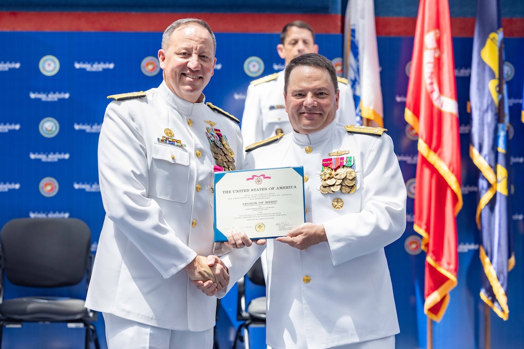 Rear Adm. Jeffrey Czerewko, left, commander, Naval Education and Training Command (NETC), receives the Legion of Merit certificate from Chief of Naval Personnel Vice Adm. Rick Cheeseman during NETC’s change of command ceremony at the National Naval Aviation Museum onboard Naval Air Station Pensacola, Florida, June 18, 2025. Rear Adm. Gregory Huffman relieved Rear Adm. Jeffrey Czerewko and became the 22nd commander of NETC. NETC's mission is to recruit, train and deliver those who serve our nation, taking them from street-to-fleet by forging civilians into highly skilled, operational and combat-ready warfighters. (United States Navy photo by Mass Communication Specialist 1st Class Zachary Melvin)