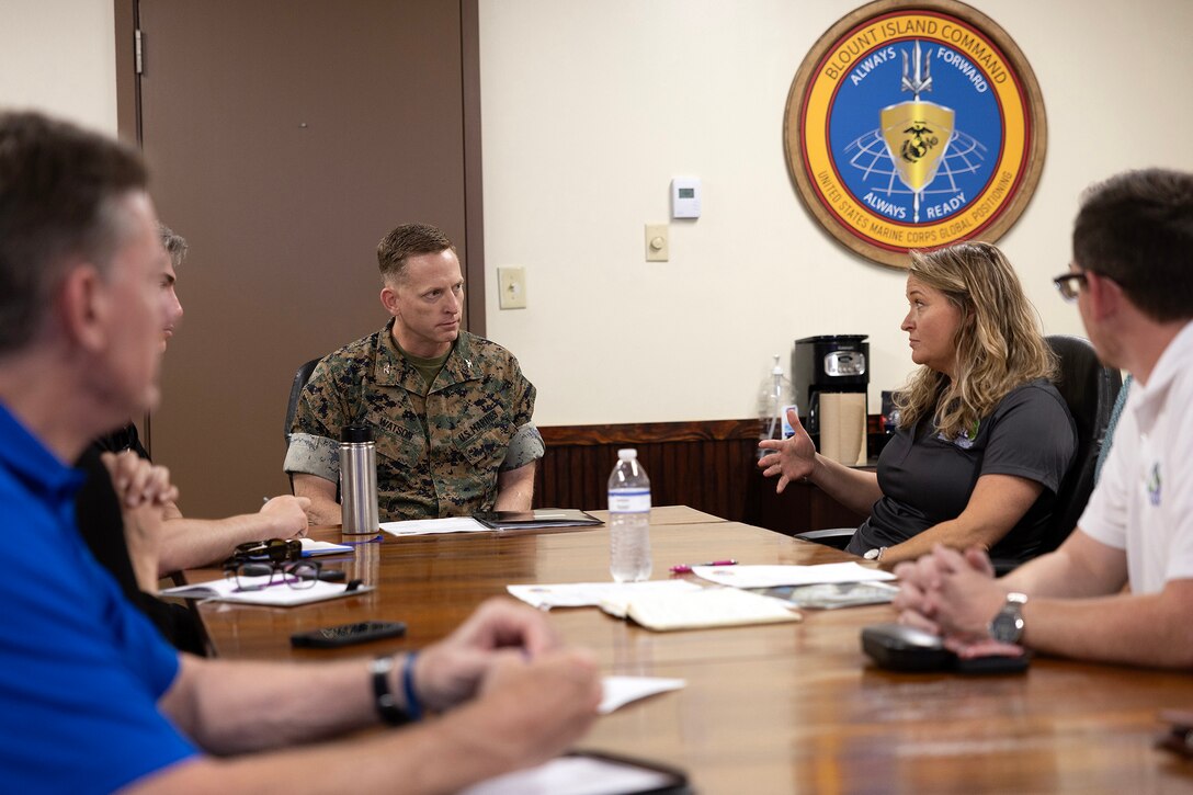 U.S. Marine Corps Col. Luke Watson, commanding officer of Blount Island Command, discusses facility vulnerabilities with a technical advisory committee for the Northeast Florida Military Installation Readiness Review during a command brief June 17 at Marine Corps Support Facility Blount Island in Florida. After a presentation on global prepositioning mission readiness, a detailed tour highlighted key challenges, including shoreline erosion. The group explored the complexities of managing power, water and wastewater systems, and the dredging needed to maintain the slipway for Navy cargo ships, as Florida communities brace for a predicted above-normal Atlantic hurricane season. (Official U.S. Marine Corps Photo/Dustin Senger)