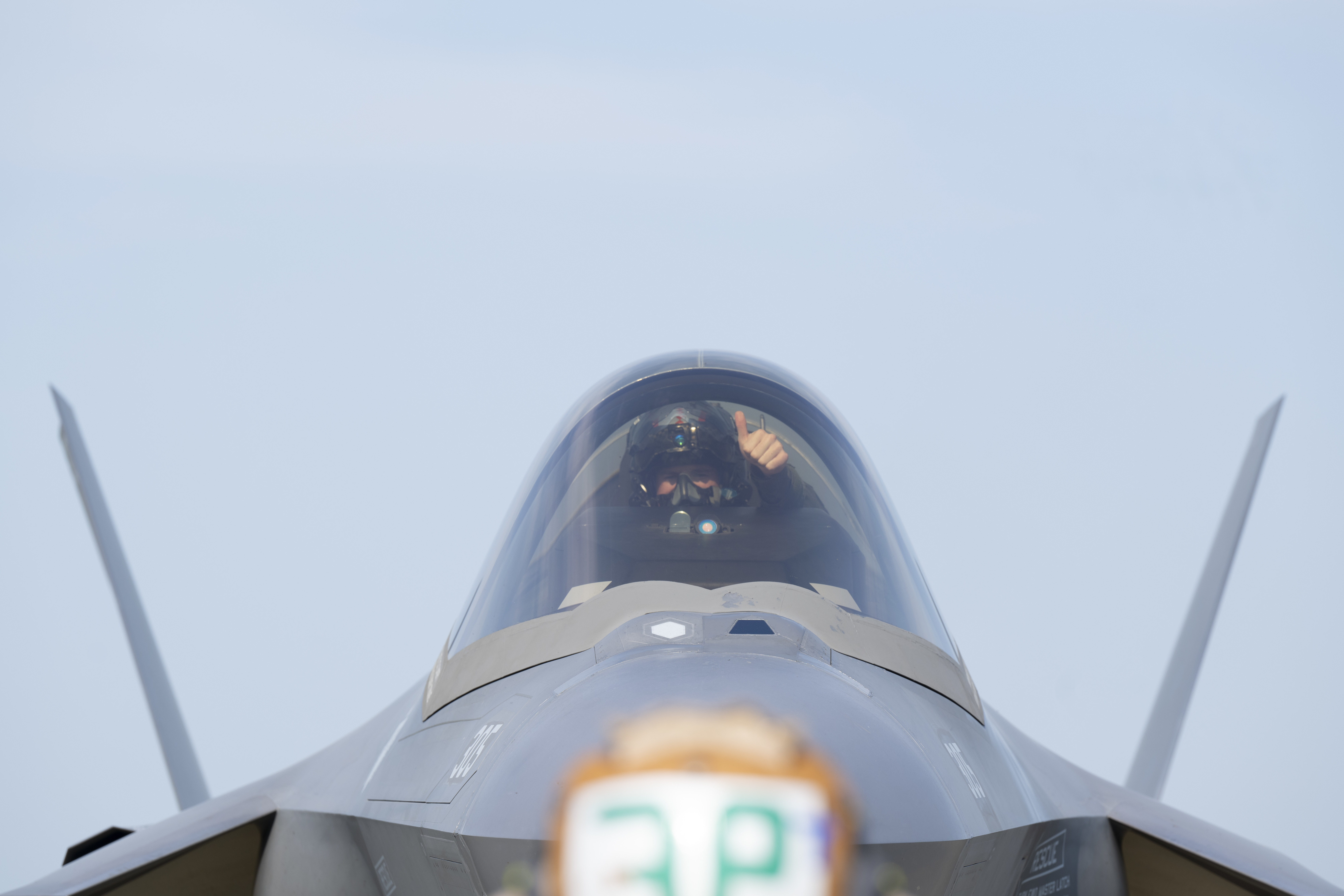 U.S. Navy Lt. Austin “Chuck E Chaids” Douglas, Strike Fighter Squadron (VFA) 86 F-35C pilot, signals to Seaman Yevheniy Lyashenko, an Airframe Airman with the VFA-86, during preflight checks during Red Flag-Alaska 25-2 at Eielson Air Force Base, Alaska, June 18, 2025. Each launch is part of a larger mission to strengthen the joint force and prepare for conflict through integrated training. (U.S. Air Force photo by Staff Sgt. Daniel Brosam)
