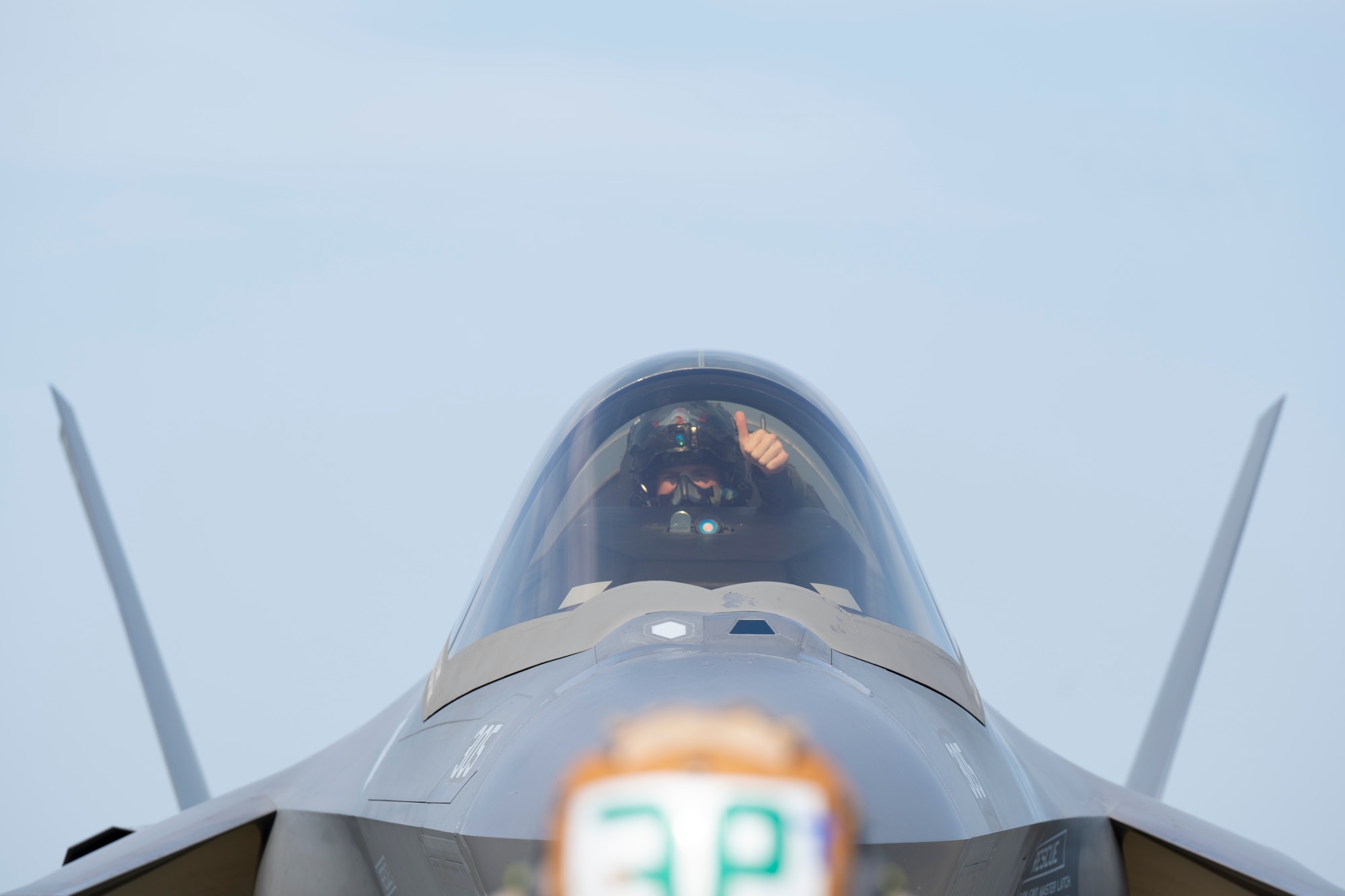 U.S. Navy Lt. Austin “Chuck E Chaids” Douglas, Strike Fighter Squadron (VFA) 86 F-35C pilot, signals to Seaman Yevheniy Lyashenko, an Airframe Airman with the VFA-86, during preflight checks during Red Flag-Alaska 25-2 at Eielson Air Force Base, Alaska, June 18, 2025.