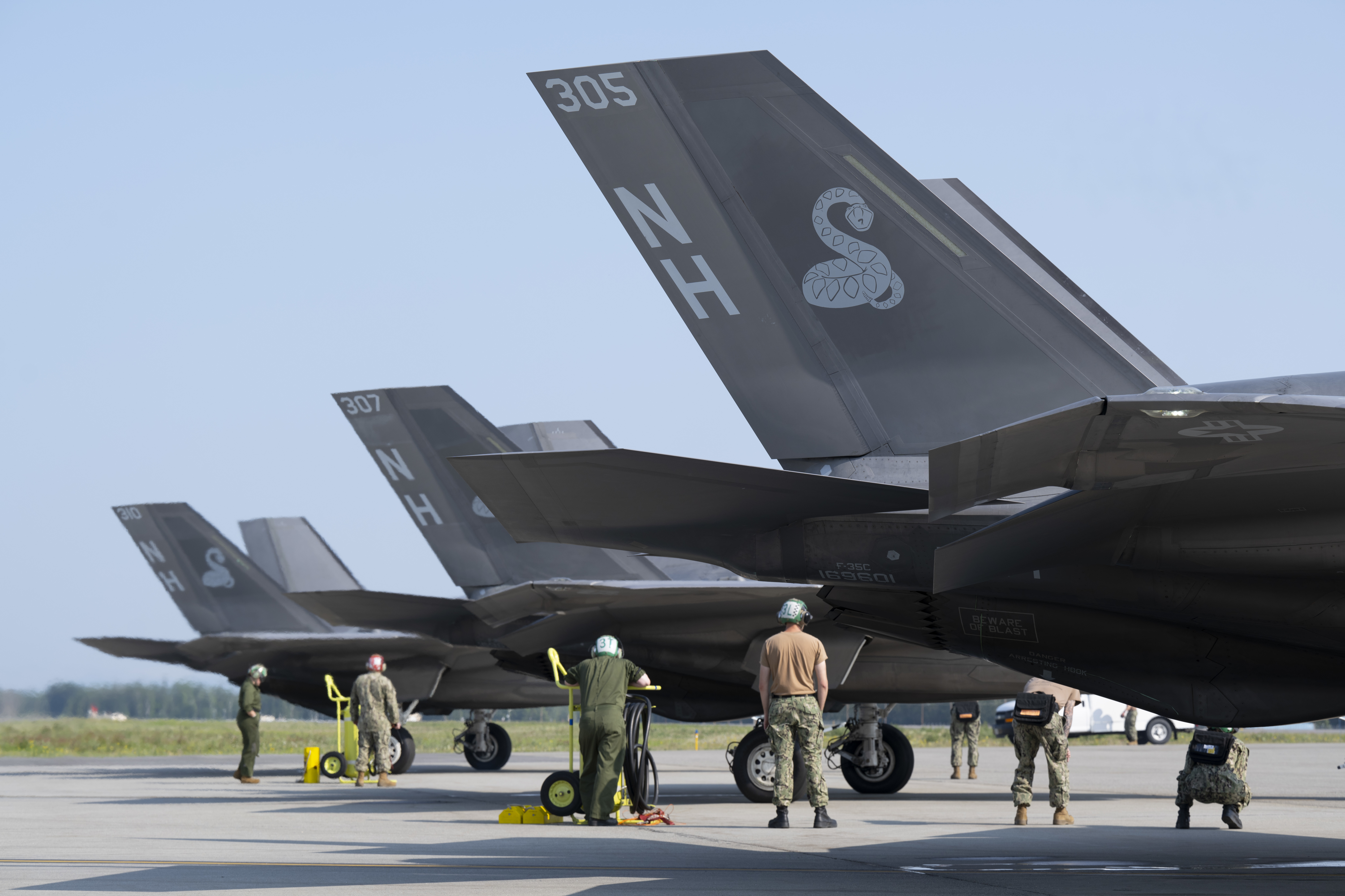 U.S. Navy sailors prepare F-35C Lightning IIs for takeoff during Red Flag-Alaska 25-2 at Eielson Air Force Base, Alaska, June 18, 2025. Each launch is part of a larger mission to strengthen the joint force and prepare for conflict through integrated training. (U.S. Air Force photo by Staff Sgt. Daniel Brosam)