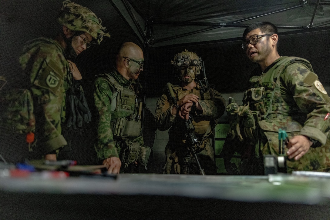 U.S. Marine Corps 1st Lt. Jonathan Berklich, a ground intelligence officer with Weapons Company, 2nd Battalion, 1st Marine Regiment, Marine Rotational Force – Darwin 25.3, conducts planning with members of the Japan Ground Self-Defense Force during Exercise Southern Jackaroo at Townsville Field Training Area, Queensland, Australia, June 1, 2025.