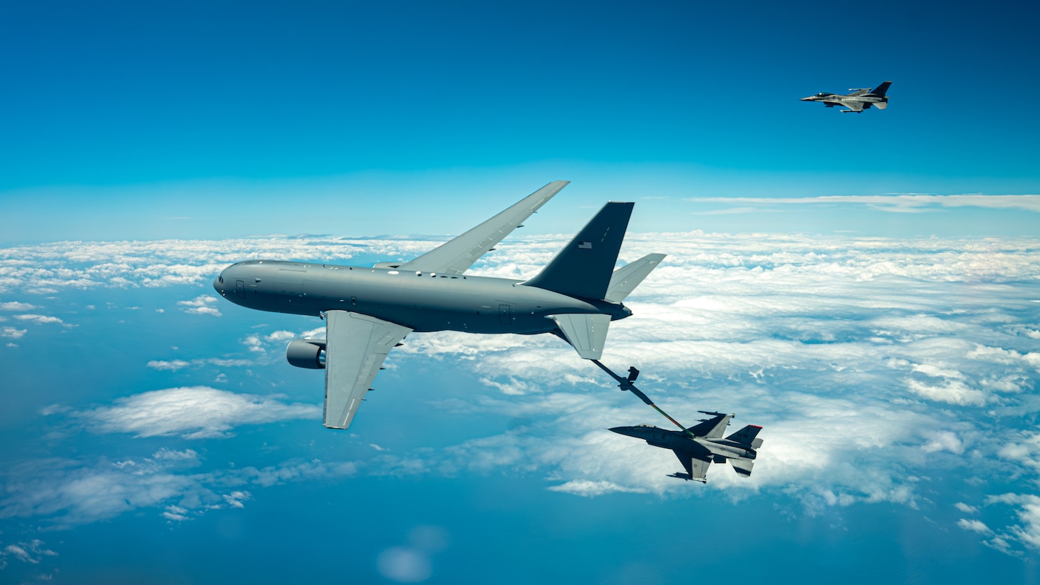 A KC-46 refuels F-16s