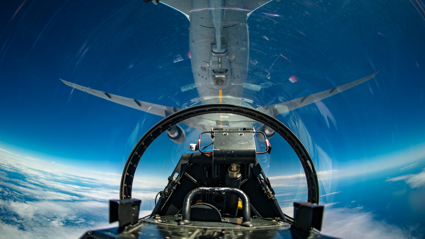 An F-16 is refueled by a KC-46 as seen from the cockpit of an F-16