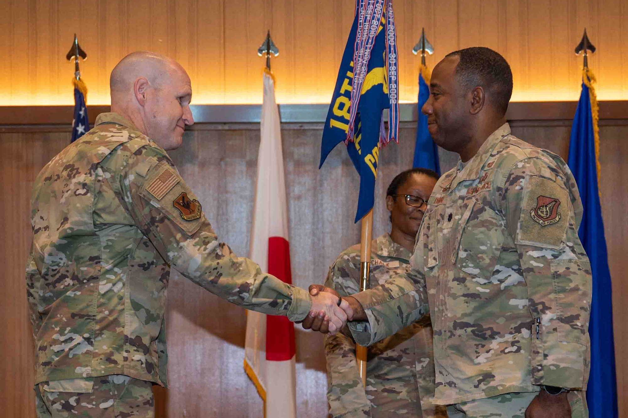 Military member shake hands at a change of command ceremony