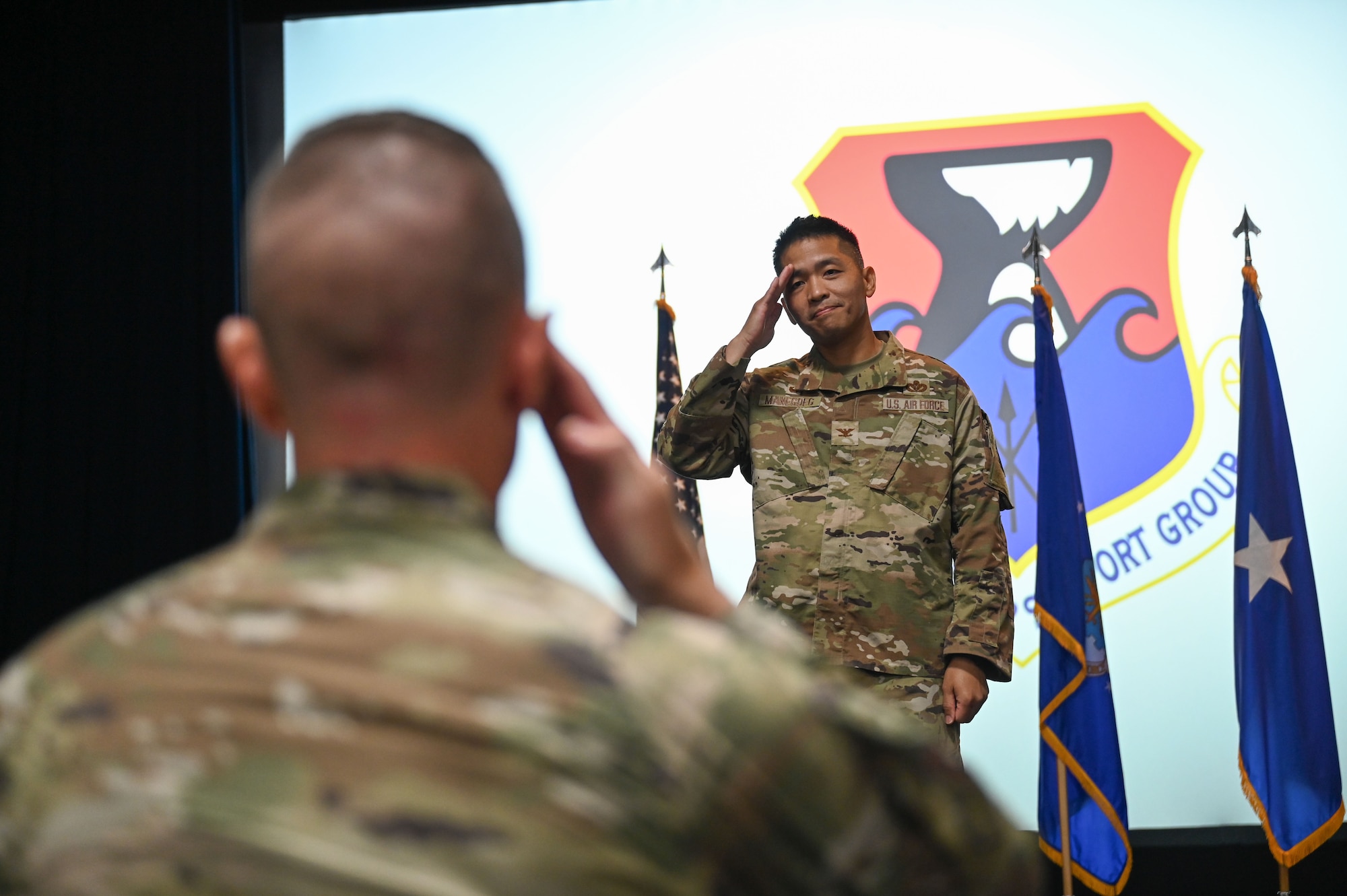 Two men salute eachother