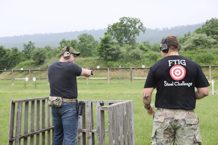 A competitor engages steel targets during the 2025 FTIG 2-Gun Steel Shoot at Fort Indiantown Gap, Pennsylvania, June 14, 2025.