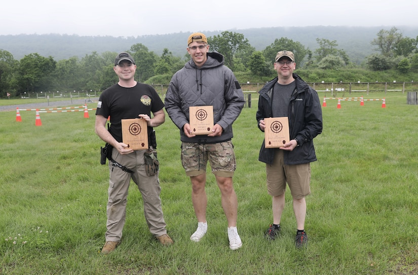 From left, U.S. Army Sgt. 1st Class Ben Harris, third place, Sgt. Matviy Korytnyuk, first place, and Col. Kevin D. Potts, second place, pose for a photo following the 2025 FTIG 2-Gun Steel Shoot at Fort Indiantown Gap, Pennsylvania, June 14, 2025.