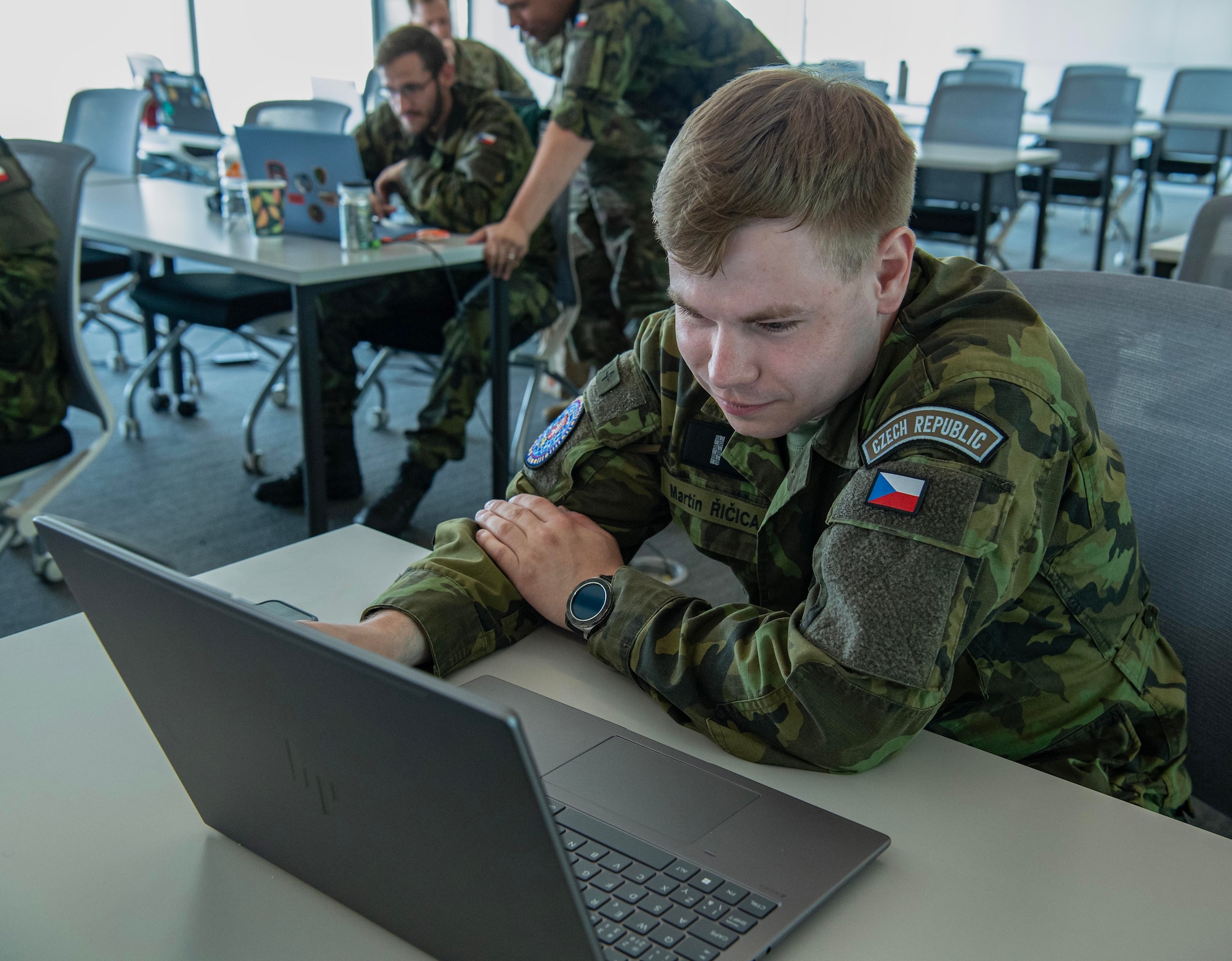 Uniformed Czech Republic soldier works on computer