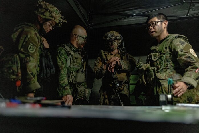U.S. Marine Corps 1st Lt. Jonathan Berklich, a ground intelligence officer with Weapons Company, 2nd Battalion, 1st Marine Regiment, Marine Rotational Force – Darwin 25.3, conducts planning with members of the Japan Ground Self-Defense Force during Exercise Southern Jackaroo at Townsville Field Training Area, Queensland, Australia, June 1, 2025.