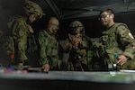U.S. Marine Corps 1st Lt. Jonathan Berklich, a ground intelligence officer with Weapons Company, 2nd Battalion, 1st Marine Regiment, Marine Rotational Force – Darwin 25.3, conducts planning with members of the Japan Ground Self-Defense Force during Exercise Southern Jackaroo at Townsville Field Training Area, Queensland, Australia, June 1, 2025.
