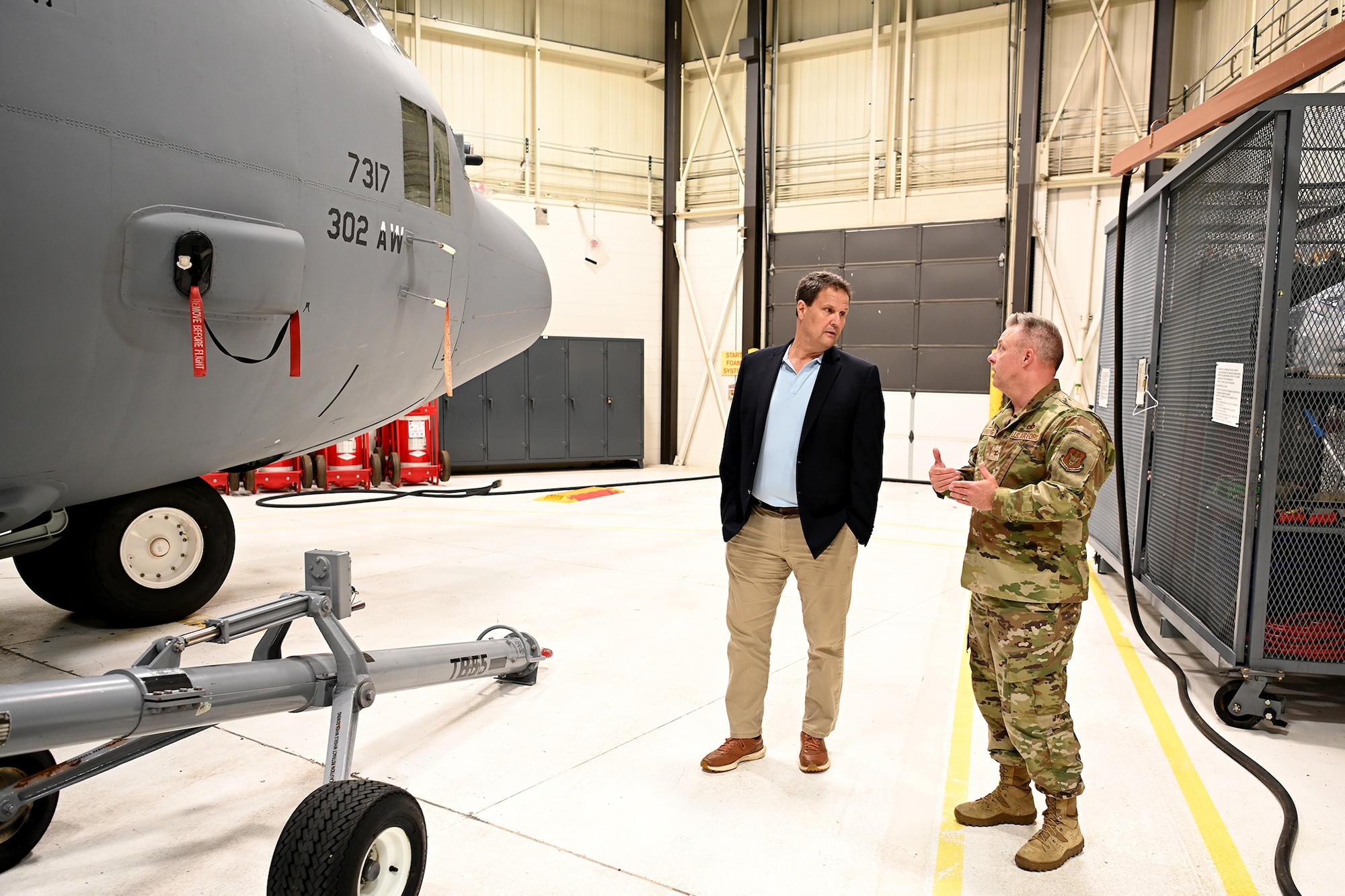 people in front of a C-130H Hercules