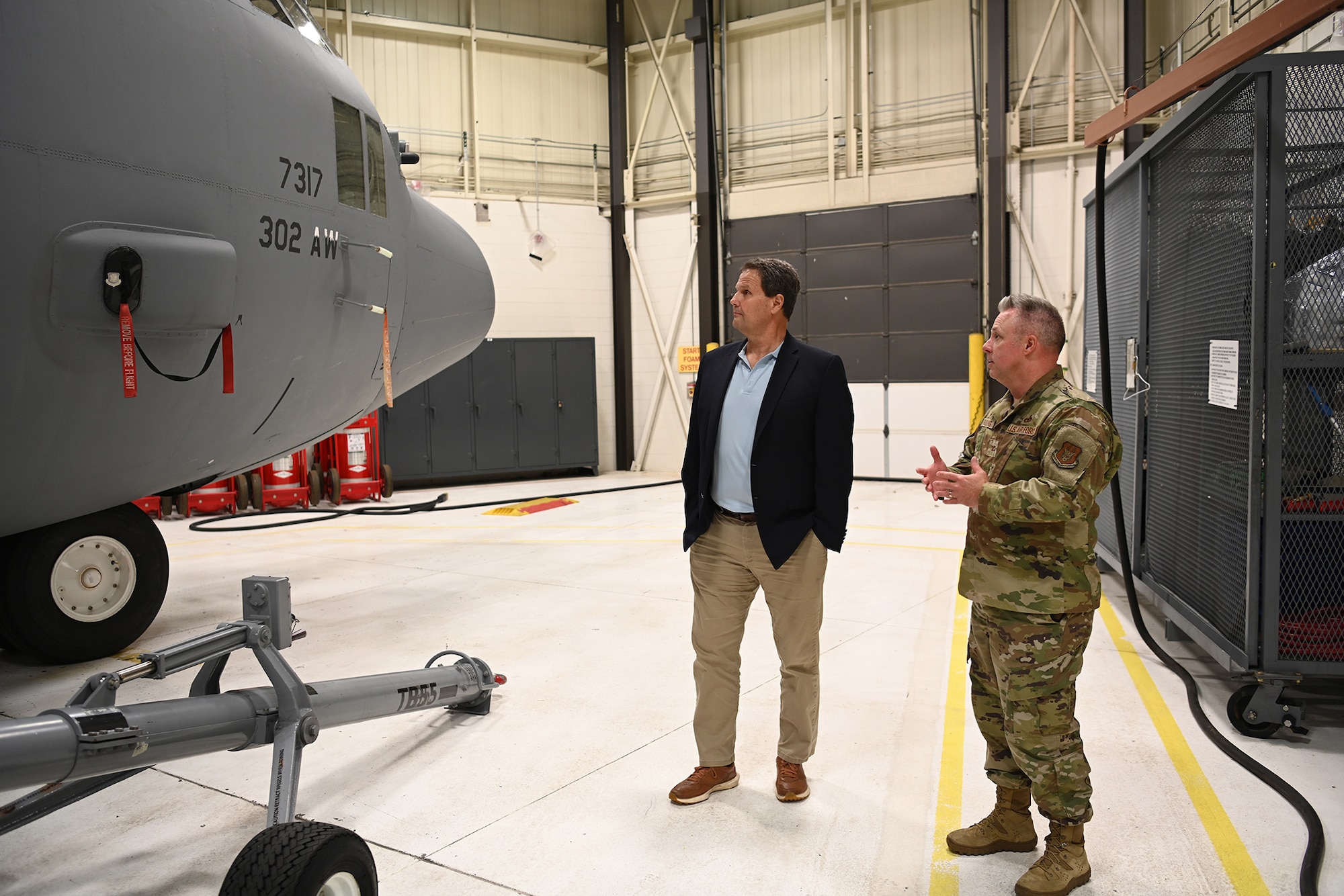 people in front of a C-130H Hercules