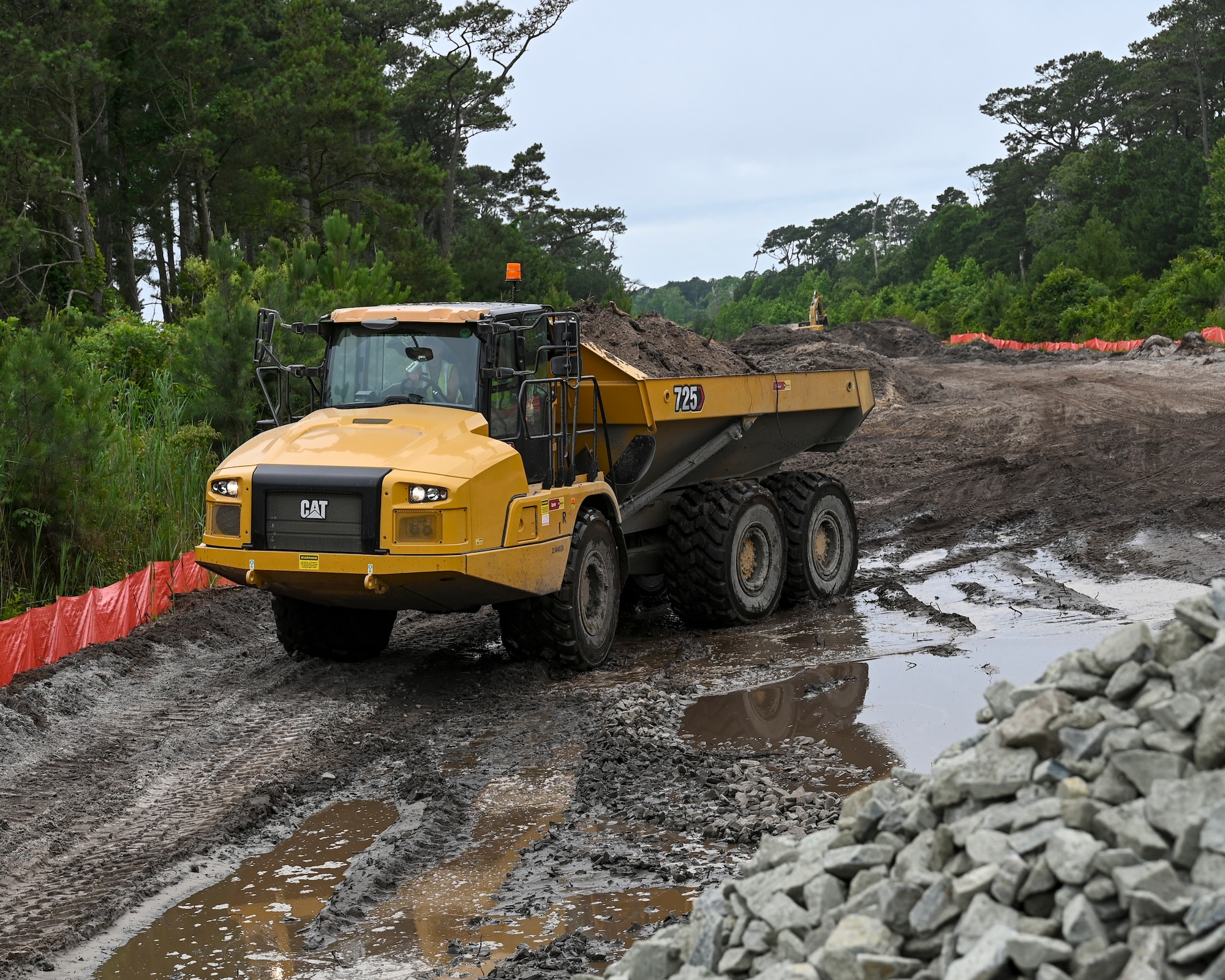 Pennsylvania Air National Guardsman assigned to the 171st Civil Engineer Squadron, operates an articulated dump truck (rock hauler) to move debris during a deployment for training, Assateague Island, Virginia, June 17, 2025. The 171st engineers are the 5th rotation of 8 during the deployment for training on the island. The DFT has provided engineers with unique training consistent with installing a runway while creating a new road for the Fish and Wildlife Service. (U.S. Air National Guard photo by Senior Master Sgt. Bryan Hoover)
