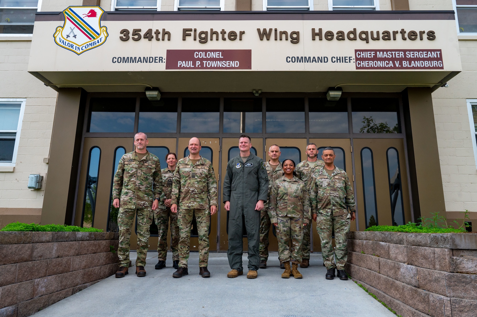 U.S. Air Force Col. Paul Townsend, 354th Fighter Wing commander, and Chief Master Sgt. Cheronica Blandburg, 354 FW command chief, pose for a photo with Belgian Armed Forces Gen. Frederik Vansina, Belgian Chief of Defence, and delegation during a briefing during a visit to Eielson Air Force Base, Alaska, June 19, 2025.