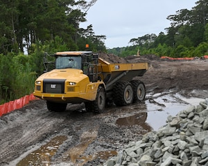 Pennsylvania Air National Guardsman assigned to the 171st Civil Engineer Squadron, operates an articulated dump truck (rock hauler) to move debris during a deployment for training, Assateague Island, Virginia, June 17, 2025. The 171st engineers are the 5th rotation of 8 during the deployment for training on the island. The DFT has provided engineers with unique training consistent with installing a runway while creating a new road for the Fish and Wildlife Service. (U.S. Air National Guard photo by Senior Master Sgt. Bryan Hoover)