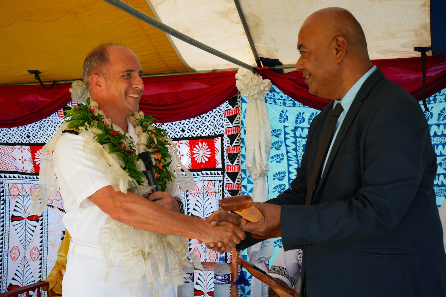 SUVA, Fiji (June 16, 2025) Capt. Mark B. Stefanik, left, mission commander of Pacific Partnership 2025 (PP-25), presents a commemorative gift to the principal of Waiqanake District School during a ribbon-cutting ceremony as part of PP-25 in Suva, Fiji, June 16, 2025. Now in its 21st iteration, the Pacific Partnership series is the largest annual multinational humanitarian assistance and disaster management preparedness mission conducted in the Indo-Pacific. Pacific Partnership works collaboratively with host and partner nations to enhance regional interoperability and disaster response capabilities, increase security and stability in the region, and foster new and enduring friendships in the Indo-Pacific. (U.S. Navy photo by Mass Communication Specialist 2nd Class Moises Sandoval/Released)