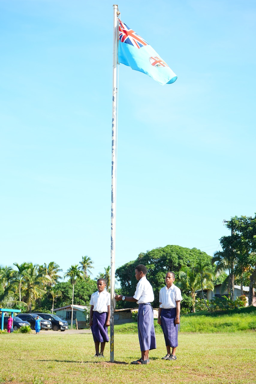 SUVA, Fiji (June 16, 2025) Students raise the Fijian flag during a ribbon-cutting ceremony at Waiqanake District School as part of Pacific Partnership 2025 in Suva, Fiji, June 16, 2025. Now in its 21st iteration, the Pacific Partnership series is the largest annual multinational humanitarian assistance and disaster management preparedness mission conducted in the Indo-Pacific. Pacific Partnership works collaboratively with host and partner nations to enhance regional interoperability and disaster response capabilities, increase security and stability in the region, and foster new and enduring friendships in the Indo-Pacific. (U.S. Navy photo by Mass Communication Specialist 2nd Class Moises Sandoval/Released)
