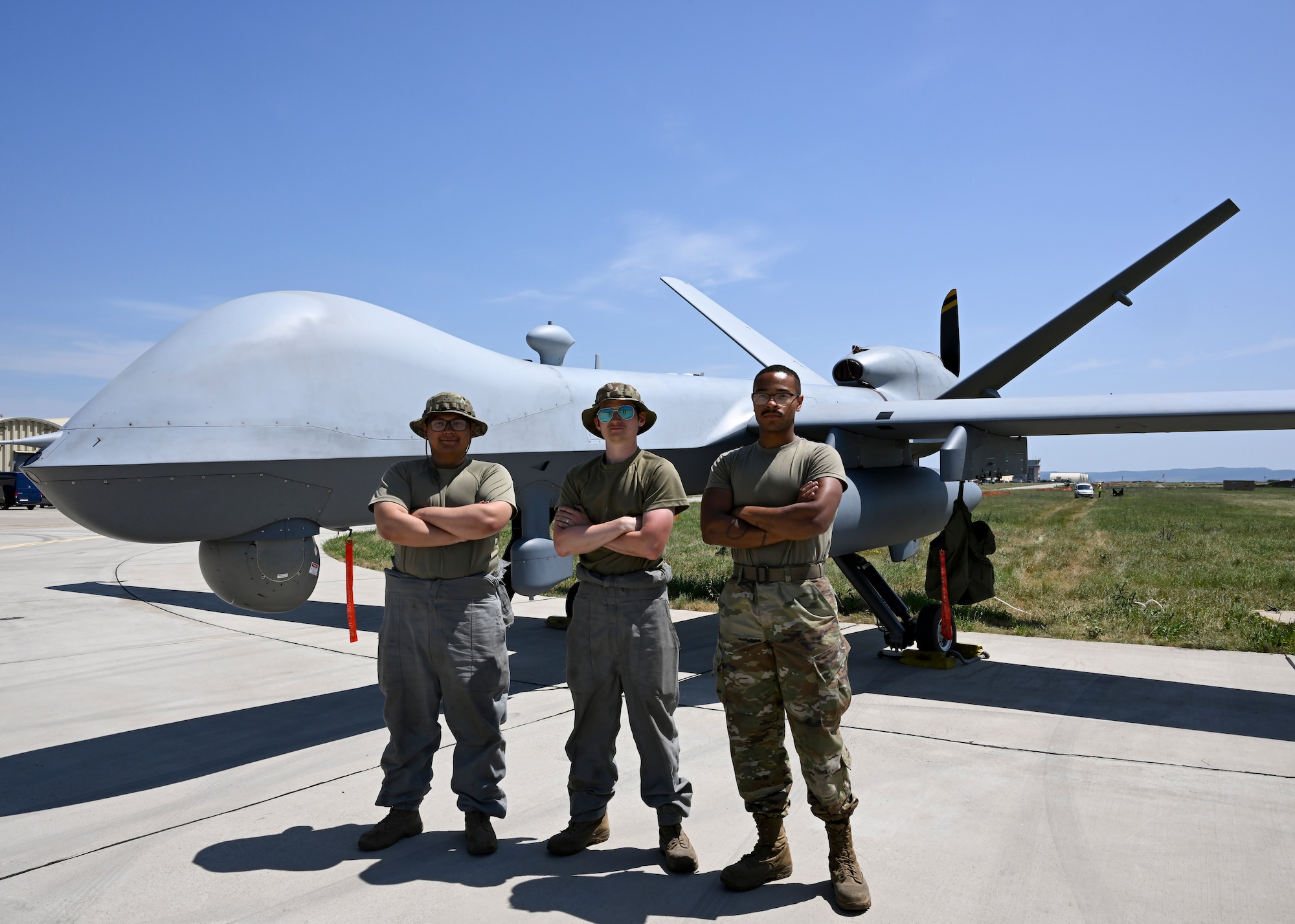 Airmen standing in front of drone