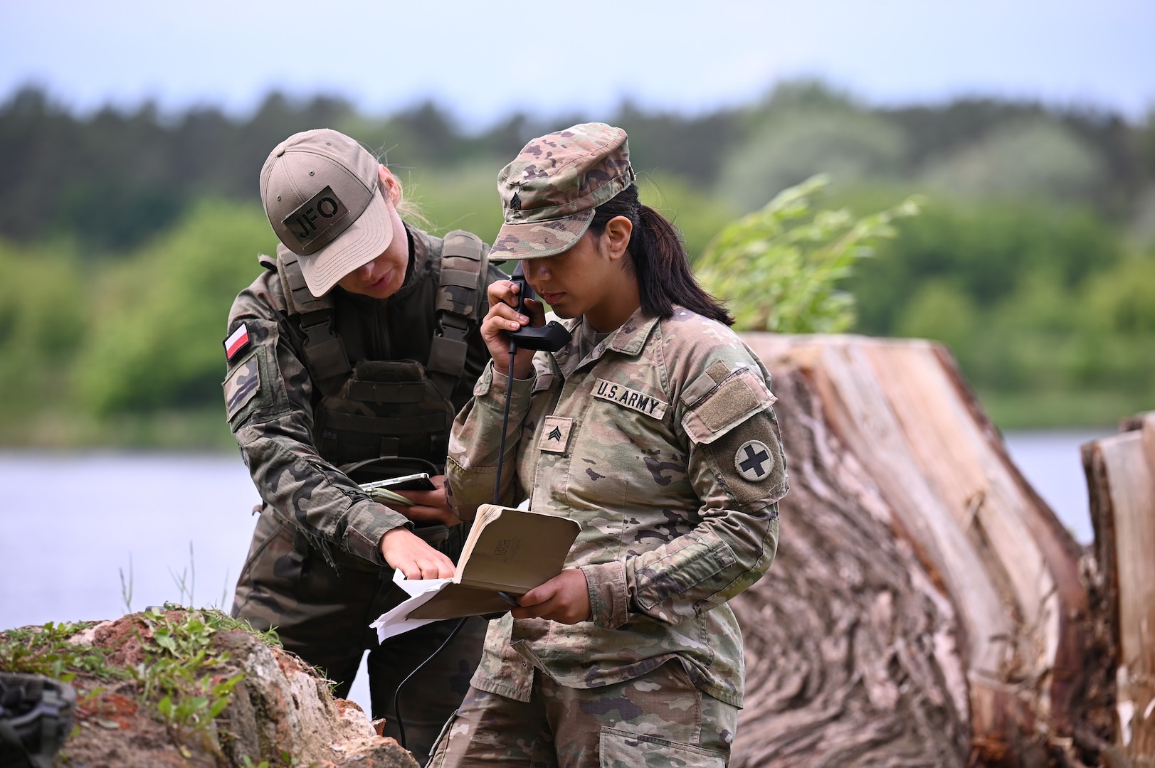 U.S. Army Sgt. Joseline Sosa, a forward observer with 1st Battalion, 178th Infantry Regiment, Illinois Army National Guard, receives information from her Polish counterparts during training on remote observer techniques in Toruń, Poland, June 6, 2025.