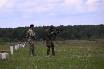 U.S. Army Sgt. Michael Rojas, a cavalry scout with C Troop, 2nd Squadron, 106th Cavalry Regiment, Illinois Army National Guard, observes as a Polish Territorial Defence soldier engages targets on a range near Toruń, Poland, June 7, 2025. The Illinois National Guard and Poland are partners in the Department of Defense National Guard State Partnership Program, which pairs Guard elements with partner nations worldwide for mutual training and subject matter expert exchanges. Servicemembers with the 33rd Infantry Brigade Combat Team are spending two weeks alongside their Polish counterparts training on sniper operations, the Javelin anti-tank weapon system, combat medical care, and remote observer techniques.