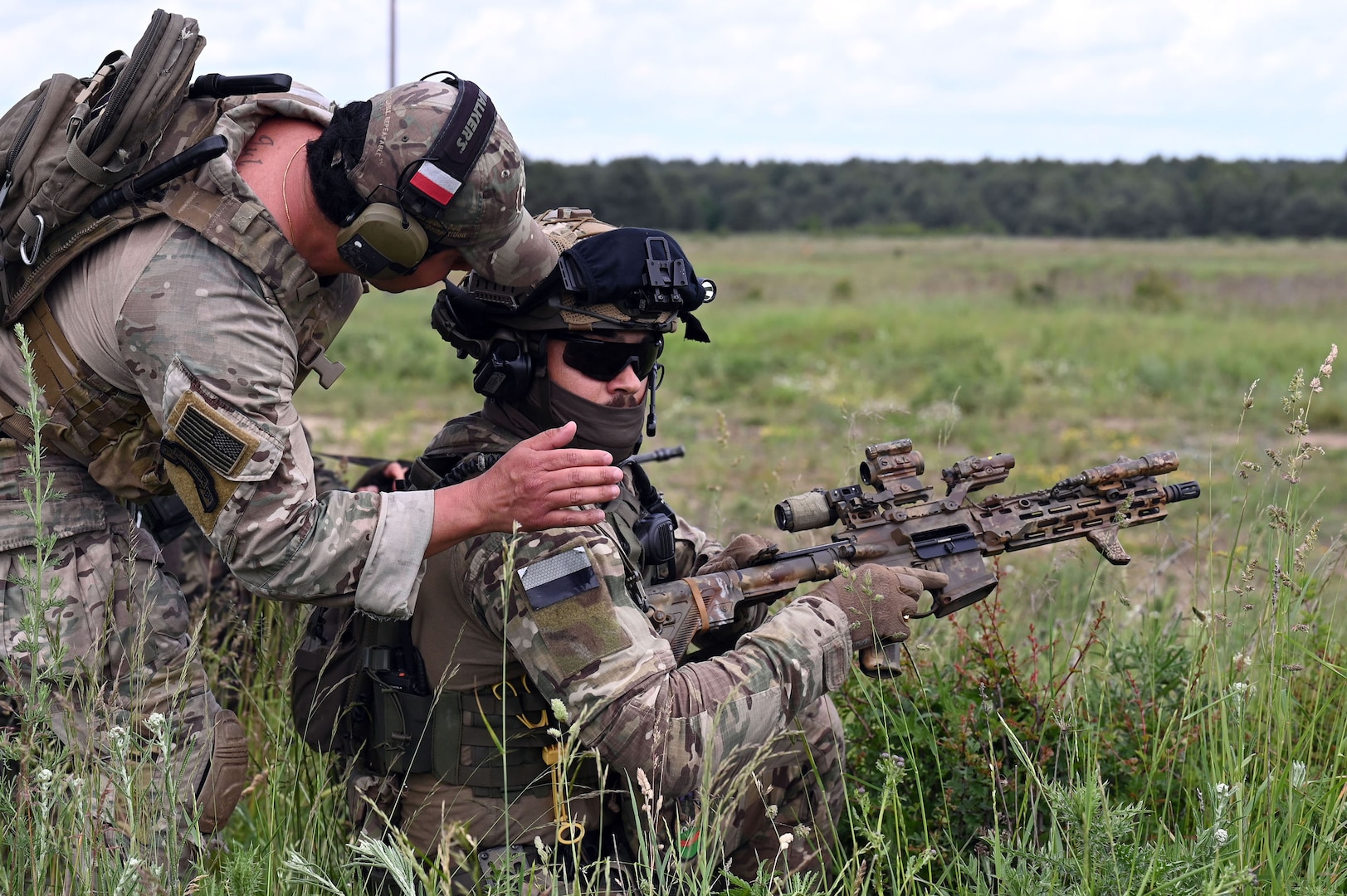 U.S. Army Staff Sgt. Bruno Rios, a cavalry scout with C Troop, 2nd Battalion, 106th Cavalry Regiment, Illinois Army National Guard, confirms that the weapon of his Polish counterpart is clear of ammunition following the completion of a shooting drill at a range near Toruń, Poland, June 7, 2025.