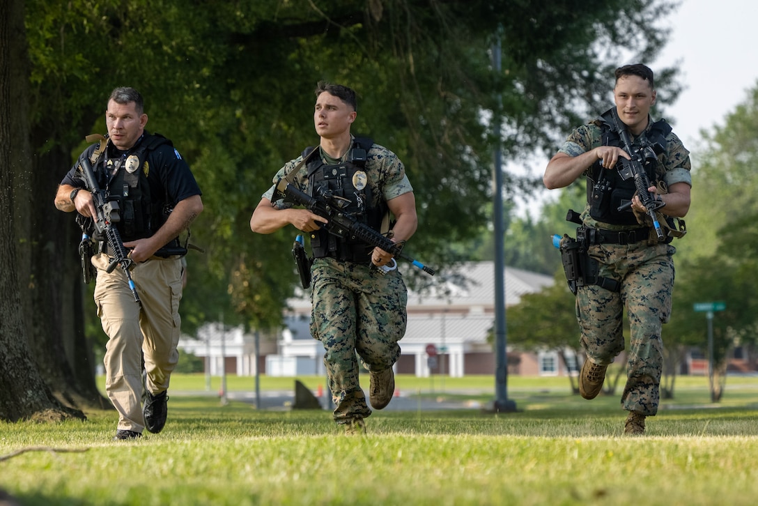 First responders with Marine Corps Base Quantico Provost Marshal Office run to Lejeune Hall during an active shooter response exercise on MCBQ, June 11, 2025. Quantico hosted a multi-jurisdictional active shooter exercise designed to strengthen first responders capabilities in emergency response and public safety operations to improve interagency communication and coordination. (U.S. Marine Corps photo by Lance Cpl. Federico Marquez)