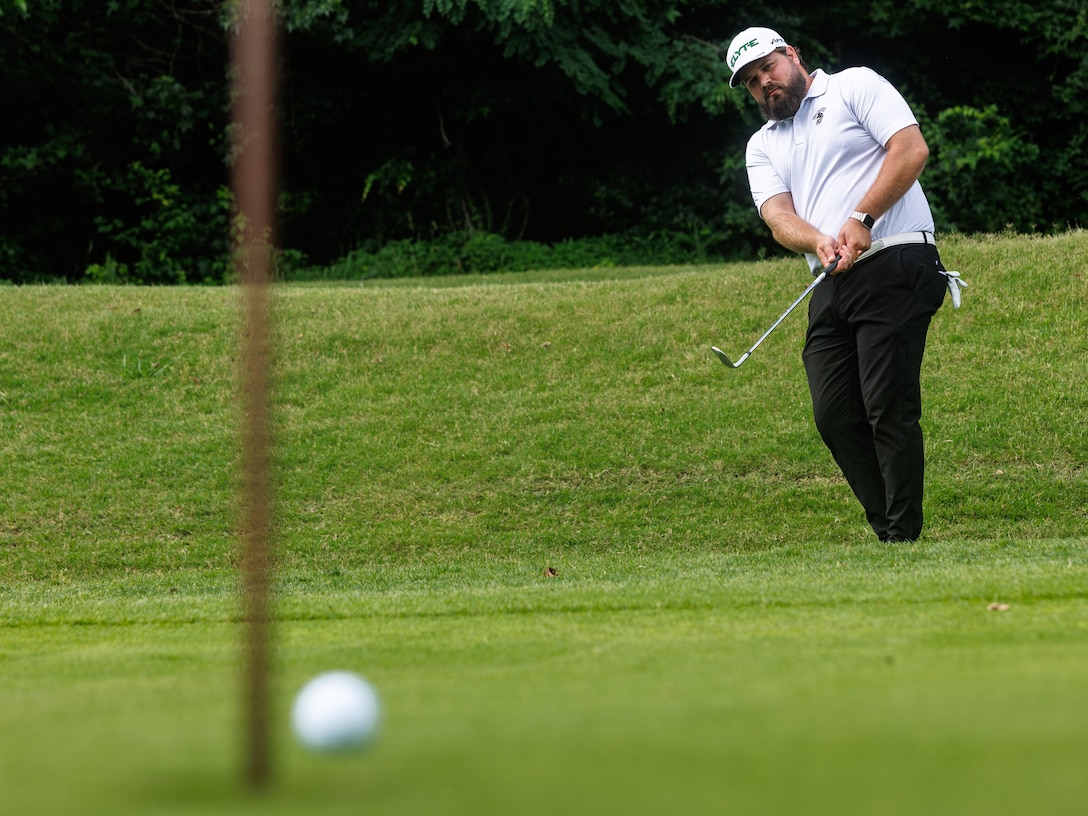 Zachary Gower, a West Virginia native and golf director at the Medal of Honor Golf Course, chips a golf ball onto the green at the MOH Golf Course on Marine Corps Base Quantico, Virginia, June 18, 2025. Gower, a top 50 golf coach for the last three years, became a lead coach for MOH Golf Course in 2018; since then, he then found fulfillment in giving back to the MCB Quantico-connected community through his passion of coaching golf. “It’s all about how many people I can help enjoy the game,” he said. (U.S. Marine Corps photo by Lance Cpl. Braydon Rogers)