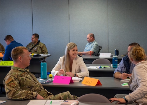 People sitting at a table working to communicate more effectively