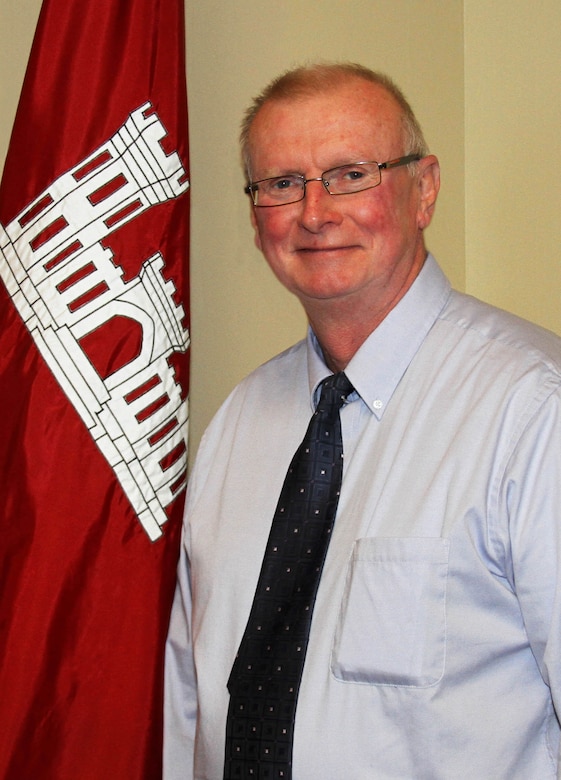 Portrait of an individual with USACE flag in background