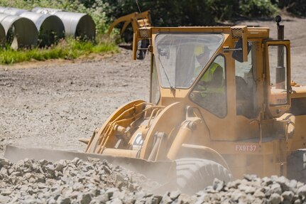 U.S. Air Force 2nd Lt. Cedar Miller, assigned to the 124th Civil Engineer Squadron, Idaho Air National Guard, transports materials to be used for a new road as part of the Redwoods Rising Innovative Readiness Training mission in California’s Redwood National and State Parks on June 17, 2025.