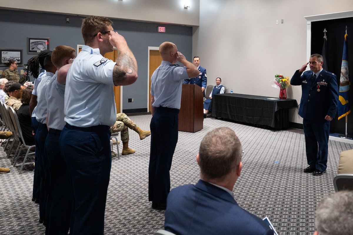 U.S. Air Force Airmen assigned to the 17th Medical Group present Col. Ian Rybczynski, outgoing 17th Medical Group commander, with his final salute upon relinquishing command at the Powell Event Center, Goodfellow Air Force Base, Texas, June 18, 2025. The 17th MDG houses the 17th Medical Operational Readiness Squadron and the 17th Healthcare Operations Squadron that provides primary care to TRICARE patients, including active duty, dependents, and retirees. (U.S. Air Force Photo by Airman 1st Class Brian Lummus)