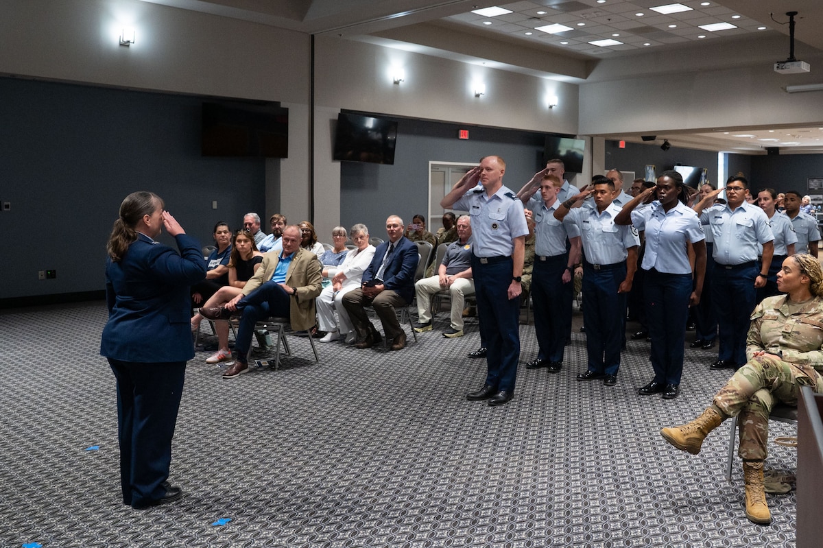 U.S. Air Force Airmen assigned to the 17th Medical Group present Col. La Rita Abel, 17th Medical Group commander, with her first salute upon taking command at the Powell Event Center, Goodfellow Air Force Base, Texas, June 18, 2025. The 17th MDG houses the 17th Medical Operational Readiness Squadron and the 17th Healthcare Operations Squadron that provides primary care to TRICARE patients, including active duty, dependents, and retirees. (U.S. Air Force Photo by Airman 1st Class Brian Lummus)