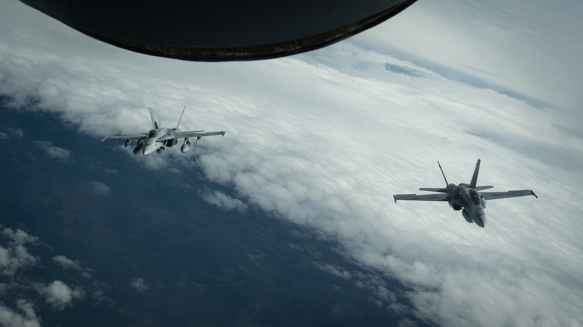 Two Finnish Air Force F/A-18 Hornets fly behind a U.S. Air Force KC-135 Stratotanker from the 100th Air Refueling Wing, RAF Mildenhall, England, during exercise Atlantic Trident 25 over Finland, June 18, 2025.