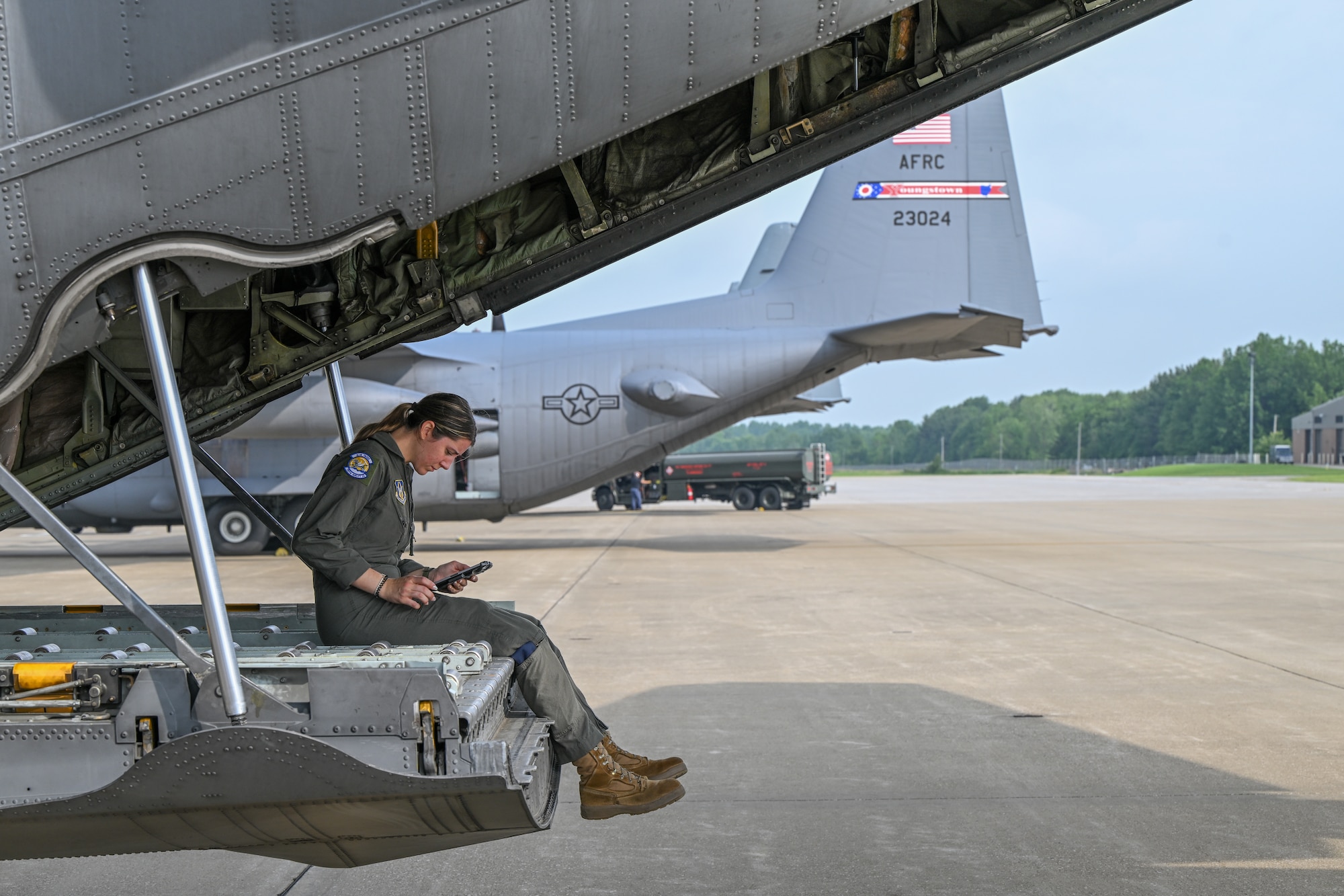Airman sitting on a C-130 ramp