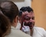 U.S. Air Force Staff Sgt. Olivia Hightower, 5th Medical Group (5MDG) NCOIC of education and training, applies moulage makeup to U.S. Air Force Cap. Jonathan Castillo, 5MDG pediatric nurse, at Minot Air Force Base, North Dakota, June 11, 2025. Moulage is an art of special effects makeup used to replicate various disease processes or injuries for training. (U.S. Air Force photo by Airman 1st Class Wesley Davies)