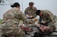 Airmen from the 5th Medical Group assess and treat simulated injuries for a training event at Minot Air Force Base, North Dakota, June 11, 2025. The 5MDG gathered volunteers to wear moulage makeup to participate in training Airmen with assessing and treating injuries. (U.S. Air Force photo by Airman 1st Class Wesley Davies)