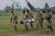 Airmen from the 5th Medical Group (5MDG)  carry a volunteer from a 54th Helicopter Squadron (54HS) UH-1N Iroquois helicopter on a stretcher at Minot Air Force Base, North Dakota, June 11, 2025. The 54HS participated in the training exercise to strengthen cross-functional teamwork between the 5MDG and flying units during high impact training beyond routine clinic operations. (U.S. Air Force photo by Airman 1st Class Wesley Davies)