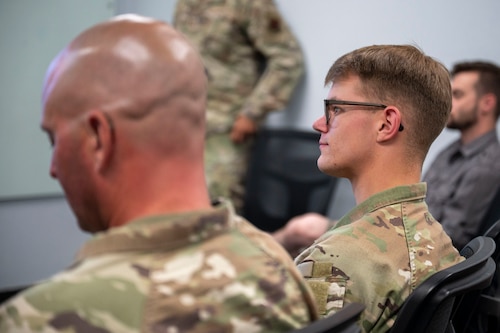 A U.S. Air Force maintainer assigned to the 355th Component Maintenance Squadron listens to a Maintainers in Action kick off briefing at Davis-Monthan Air Force Base, Arizona, June 12, 2025. Maintainers in Action will serve as force multipliers for the Religious Support Team so that every Airman has access to care when they need it most. (U.S. Air Force photo by Airman Samantha Melecio)
