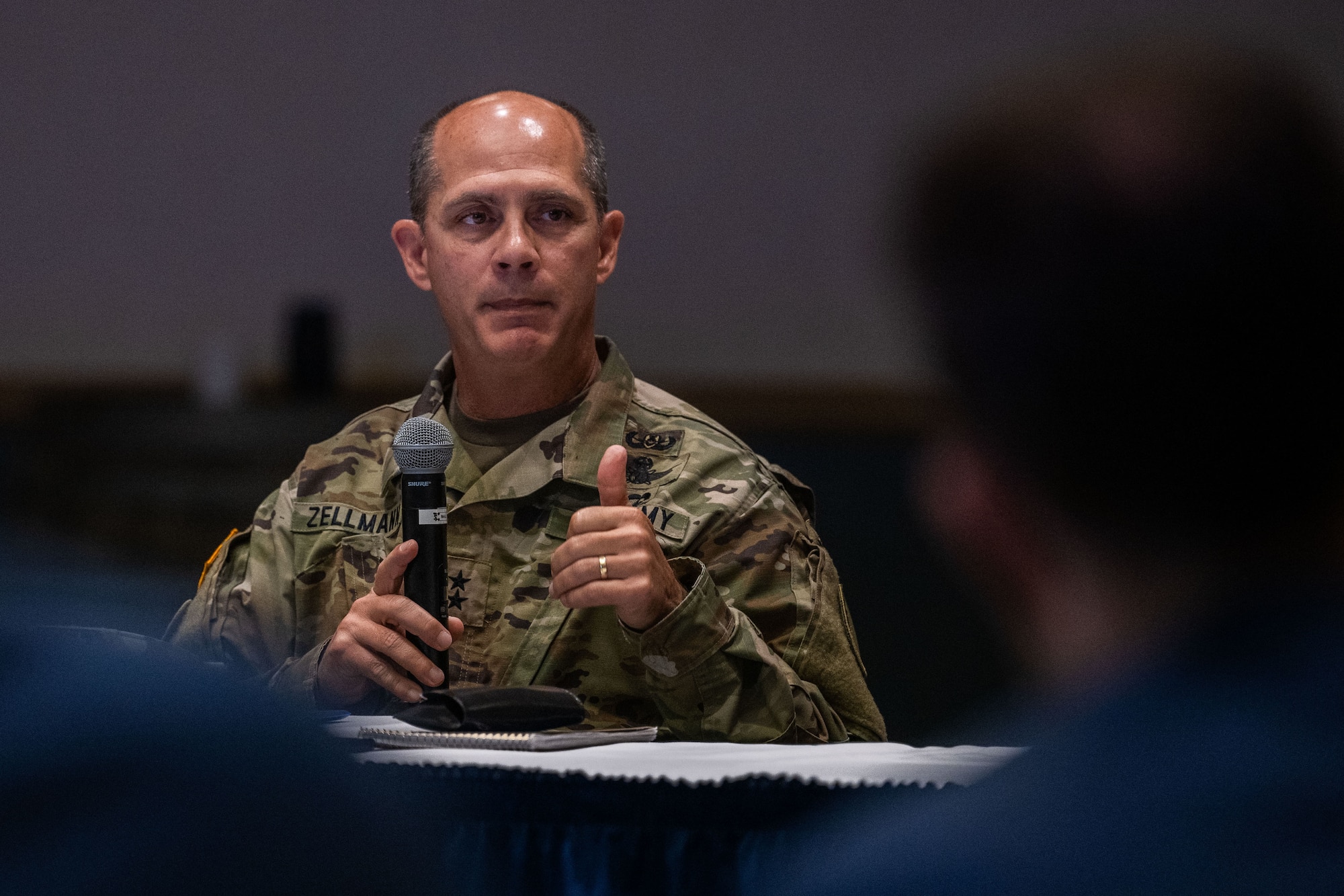 An Army General speaks into a microphone.