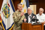 photos of the adjutant general in uniform talking at a press conference with the governor, visiting people, sitting around a conference table.