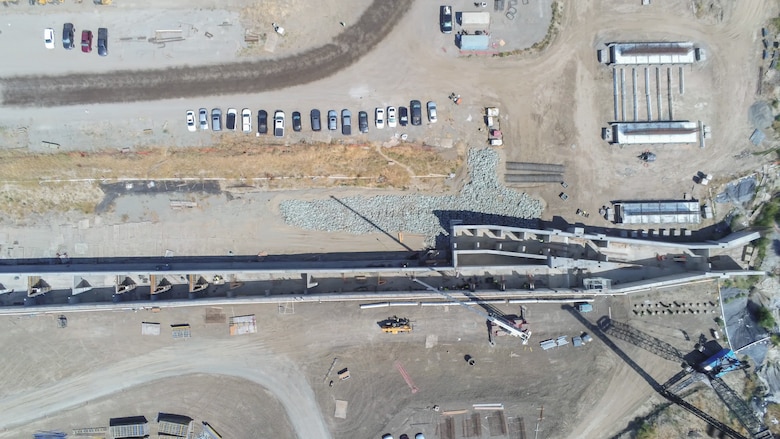 An overhead aerial view shows construction of the fish passage structure along the west bank of the Sacramento River in Yolo County, California, on June 5, 2025. The structure is part of the Sacramento Weir Widening Project managed by the U.S. Army Corps of Engineers Sacramento District, which will create an 8,600-foot "double hybrid technical fishway" for endangered salmon, steelhead and sturgeon. The $350 million project combines flood control infrastructure with fish passage capabilities to protect threatened species during high-water events.
